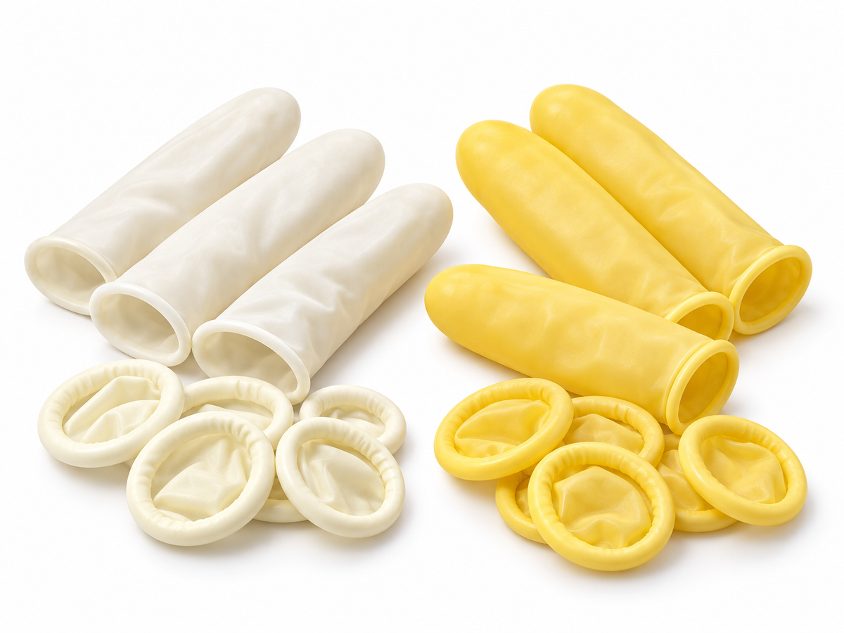 White and yellow latex finger cots, rolled and unrolled, on a white background