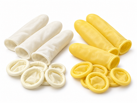 White and yellow latex finger cots, rolled and unrolled, on a white background